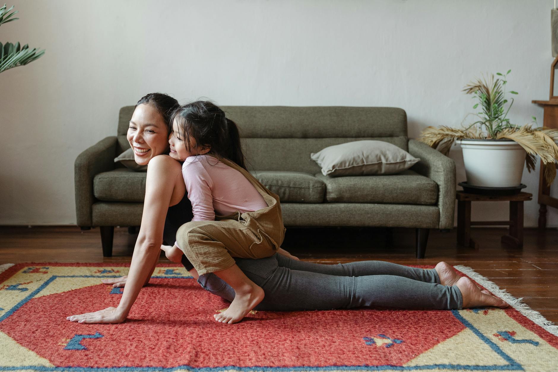 photo of girl hugging her mom while doing yoga pose, exploring meditation style, personalized meditation, traditional meditation, mindfulness habits, and mind-body connection
