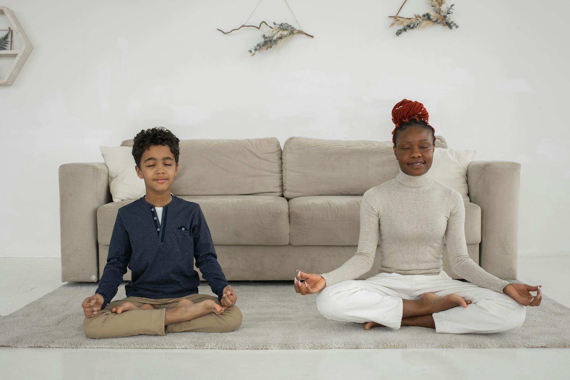 woman and little boy meditating, exploring types of meditation and meditation techniques, as well as the benefits of meditation, mindfulness meditation, and how to meditate