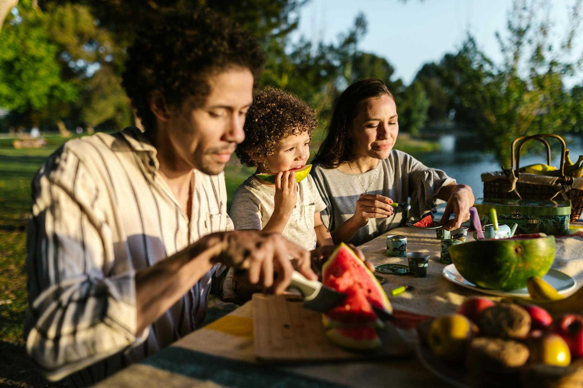 a family having a picnic during the summer solstice and the beginning of cancer season, illustrating its nurturing cardinal water qualities per Hellenistic astrology