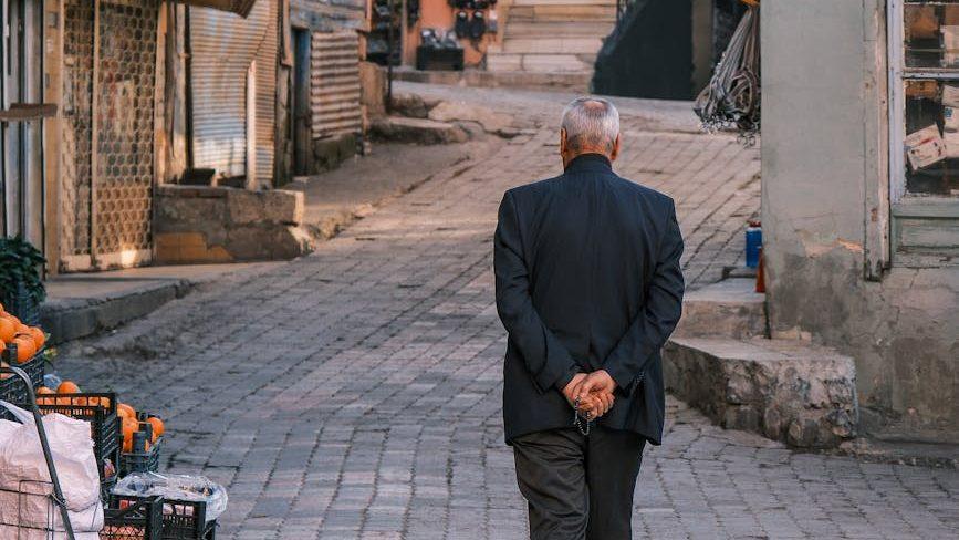 elderly man strolling down historic alleyway, contemplating meditation for daily life, mindfulness routines, daily meditation practice, mindfulness habits, and how to integrate meditation