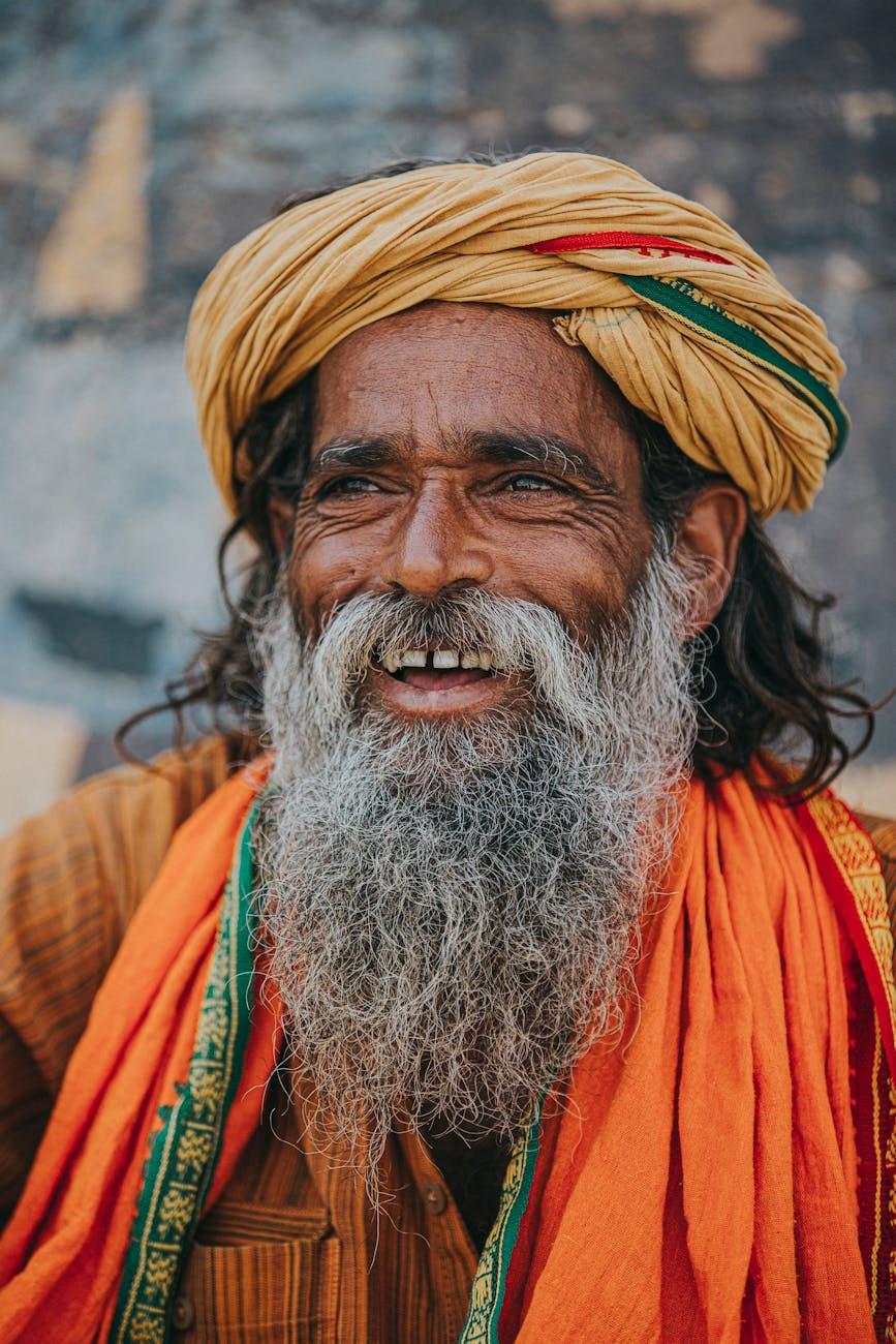 joyful sadhu in vibrant attire varanasi, considering spiritual connection, meditation practice, mindfulness and intuition, connect with higher self, and meditation for inner peace