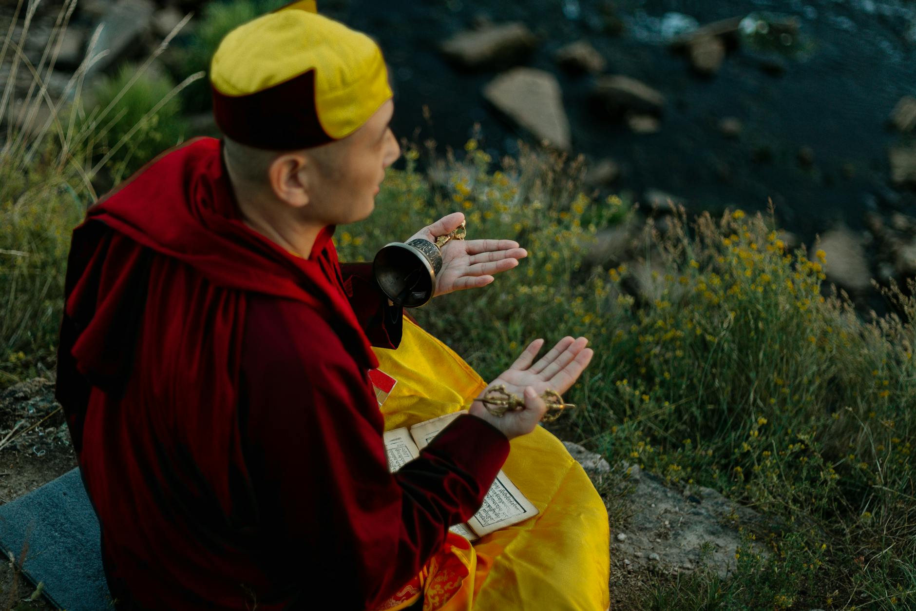 a man praying while holding a bell, considering spiritual connection, meditation practice, mindfulness and intuition, connect with higher self, and meditation for inner peace