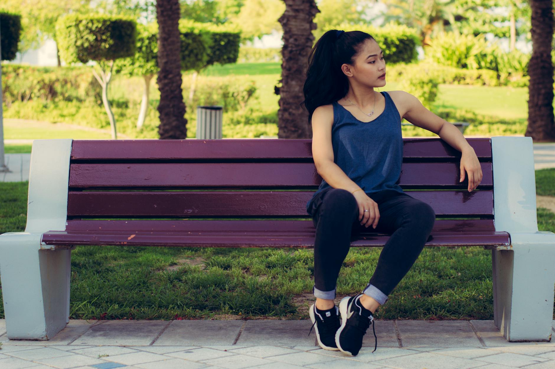 woman sitting on purple bench, considering meditation hurdles, consistent practice, sustain mindfulness, meditation obstacles, and how to meditate consistently.