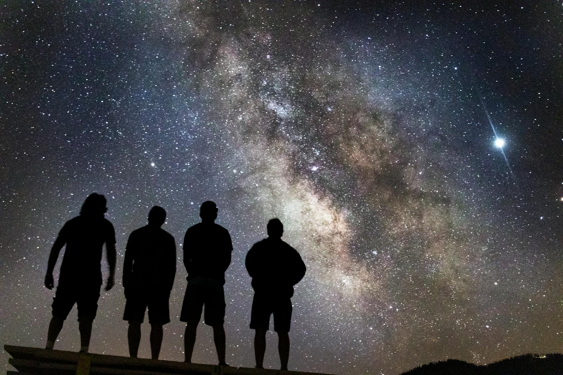 silhouette of people stargazing, illustrating spiritual growth, meditation, awareness, ego transcendence, and intuitive wisdom