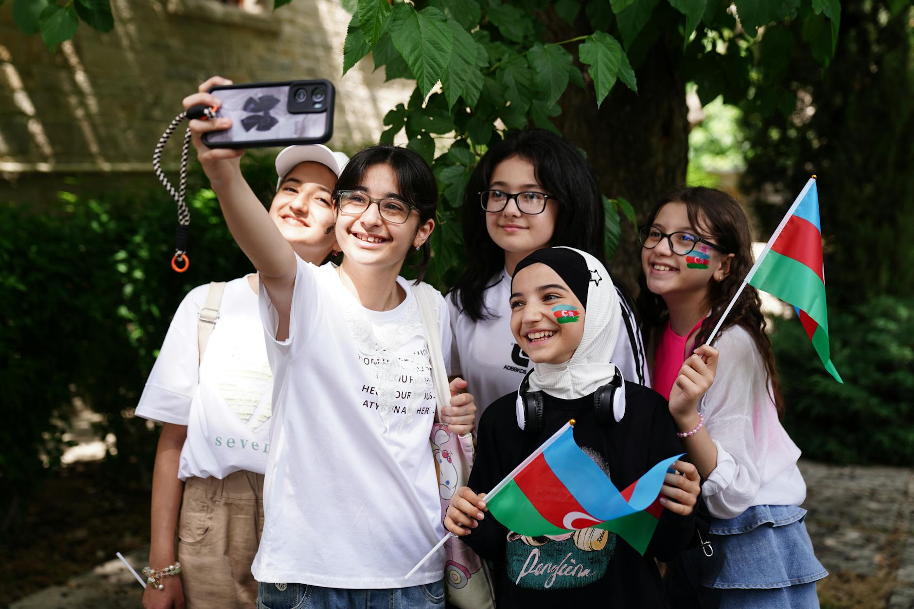 group of kids taking selfie outdoors with flags, Illustrating Technology for Self-Improvement, Productivity Apps, Positive Social Media, AI for Personal Growth, and Digital Wellness Tools