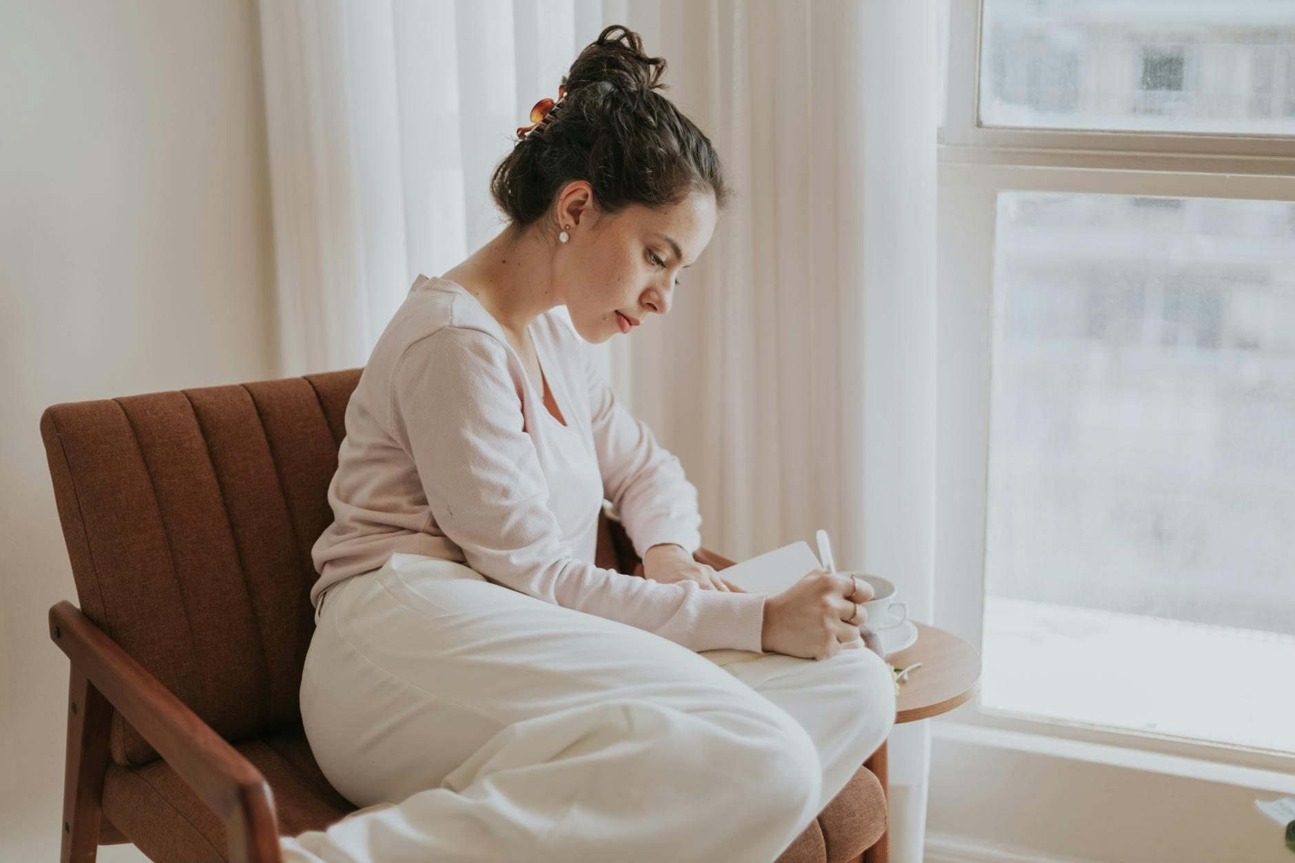 relaxed journaling by the window in natural light, evoking advanced meditation techniques, deep meditation practice, meditation journey, advanced mindfulness, and spiritual growth meditation