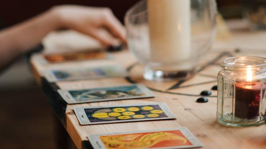 tarot cards near luminous candles for first harvest, Lammas reflections, celebrating Lughnasadh, summer harvest, gratitude ritual