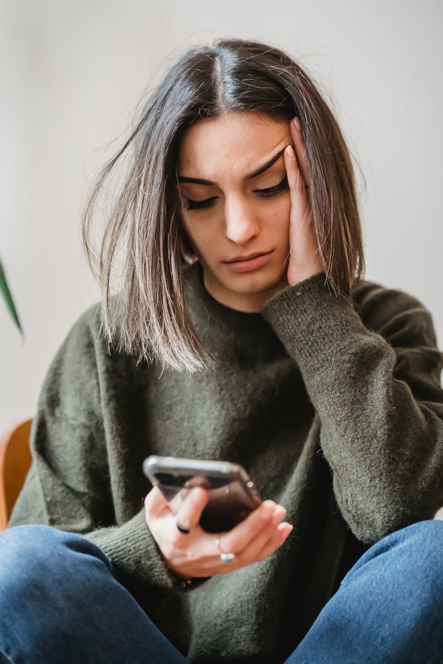 concerned woman browsing smartphone in room, Illustrating Technology for Self-Improvement, Productivity Apps, Positive Social Media, AI for Personal Growth, and Digital Wellness Tools