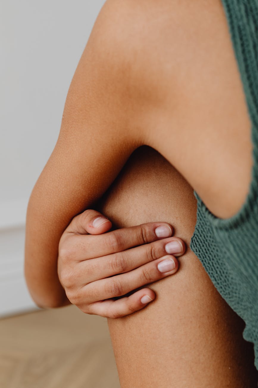 female hand and body parts in close up view, showing the importance of interconnectedness, meditation, oneness, unity and compassion, and connection with nature