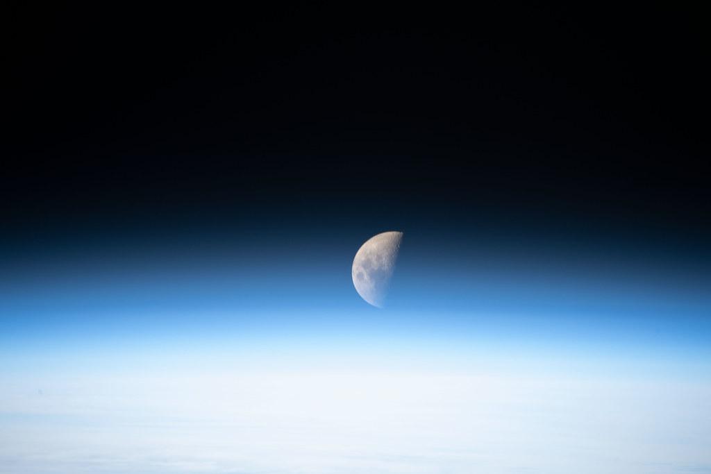 A first quarter Moon is pictured from the International Space Station, illustrating lunar cycle, moon rituals, moon phases meaning, lunar wisdom, and working with the moon