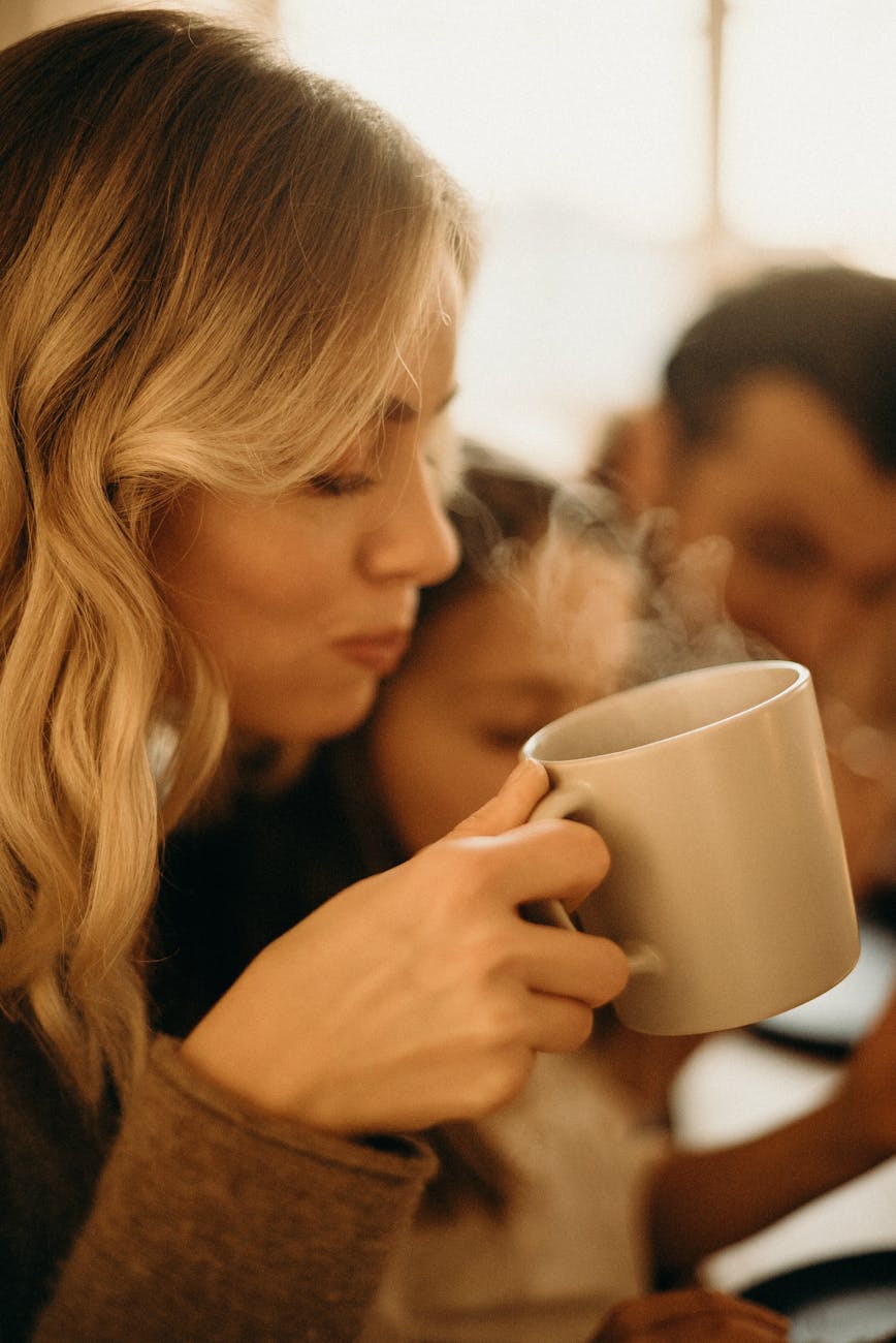 woman holding mug, illustrating: how to Celebrate Mabon, spiced apple cider recipe, autumn ritual, seasonal drink, and the Wheel of the Year