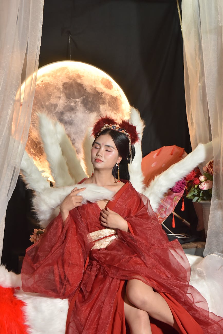 elegant woman in traditional red robe with moon backdrop, showing: moon effects on humans, lunar rhythms, lunar phases and emotions, moon influence science, and moon biological rhythms