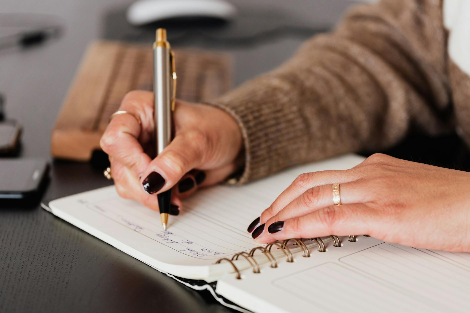 crop woman writing down notes in diary, illustrating lunar cycle, moon rituals, moon phases meaning, lunar wisdom, and working with the moon