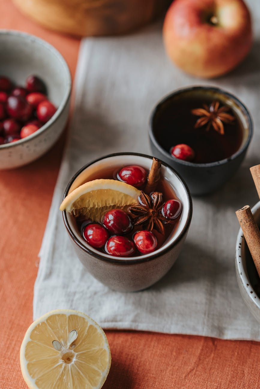 fresh fruits on mulled wine, illustrating: how to Celebrate Mabon, spiced apple cider recipe, autumn ritual, seasonal drink, and the Wheel of the Year