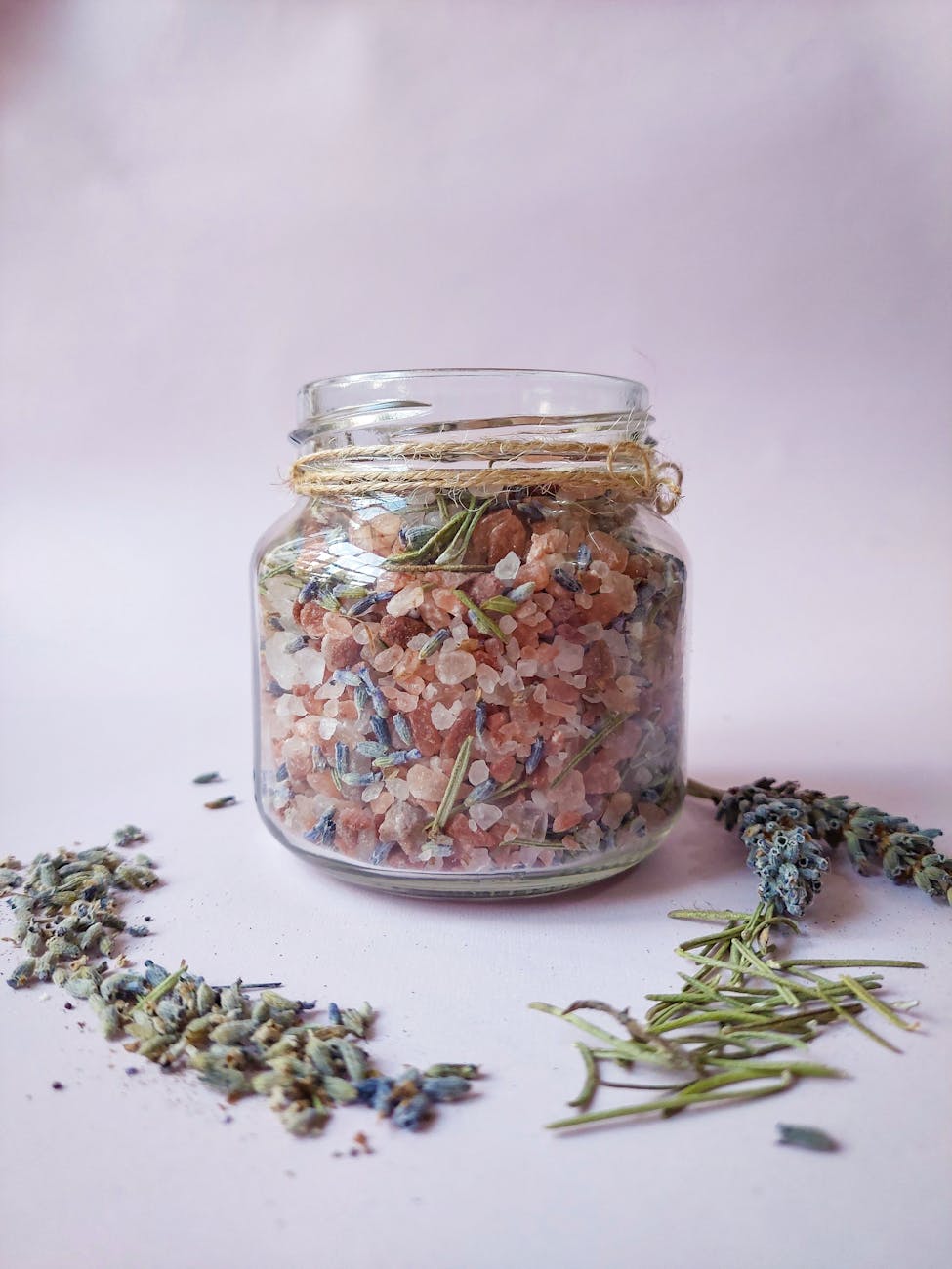 herbs and rocks in glass jar, evoking: sacred incense, incense for Samhain, ritual incense blend, herbal incense recipe, and ancestor offering incense