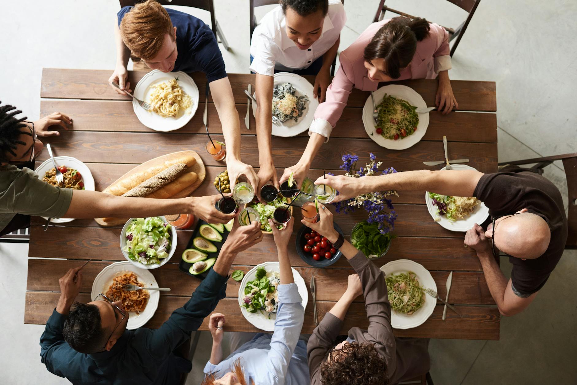 group of people making toast, illustrating: gratitude, heart-brain coherence, abundance mindset, reciprocity, and wellbeing