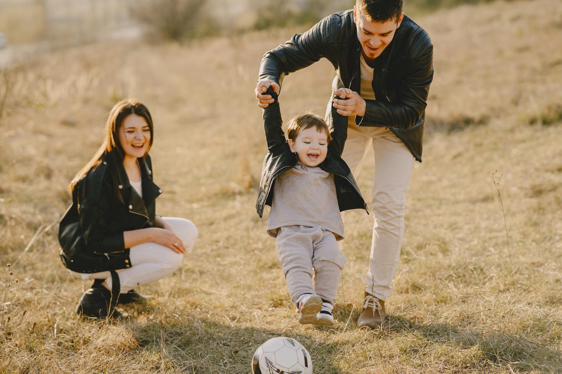 photo of family having fun with soccer ball, evoking: real manifestation, gratitude, abundance mindset, and intentional living