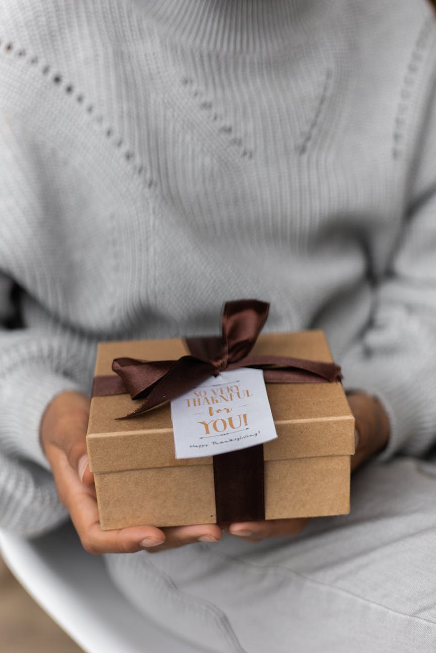 crop woman with small gift box, illustrating: gratitude, heart-brain coherence, abundance mindset, reciprocity, and wellbeing