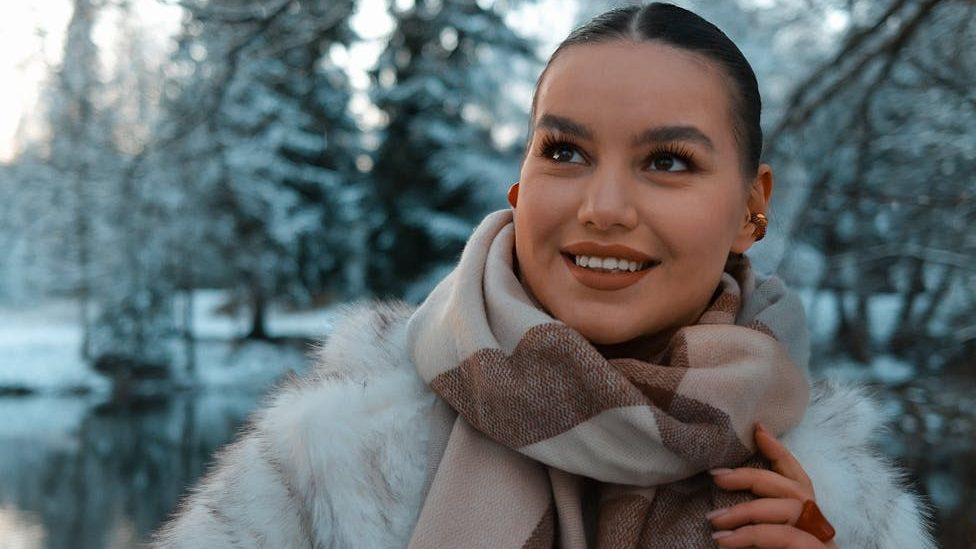 woman smiling in winter wonderland