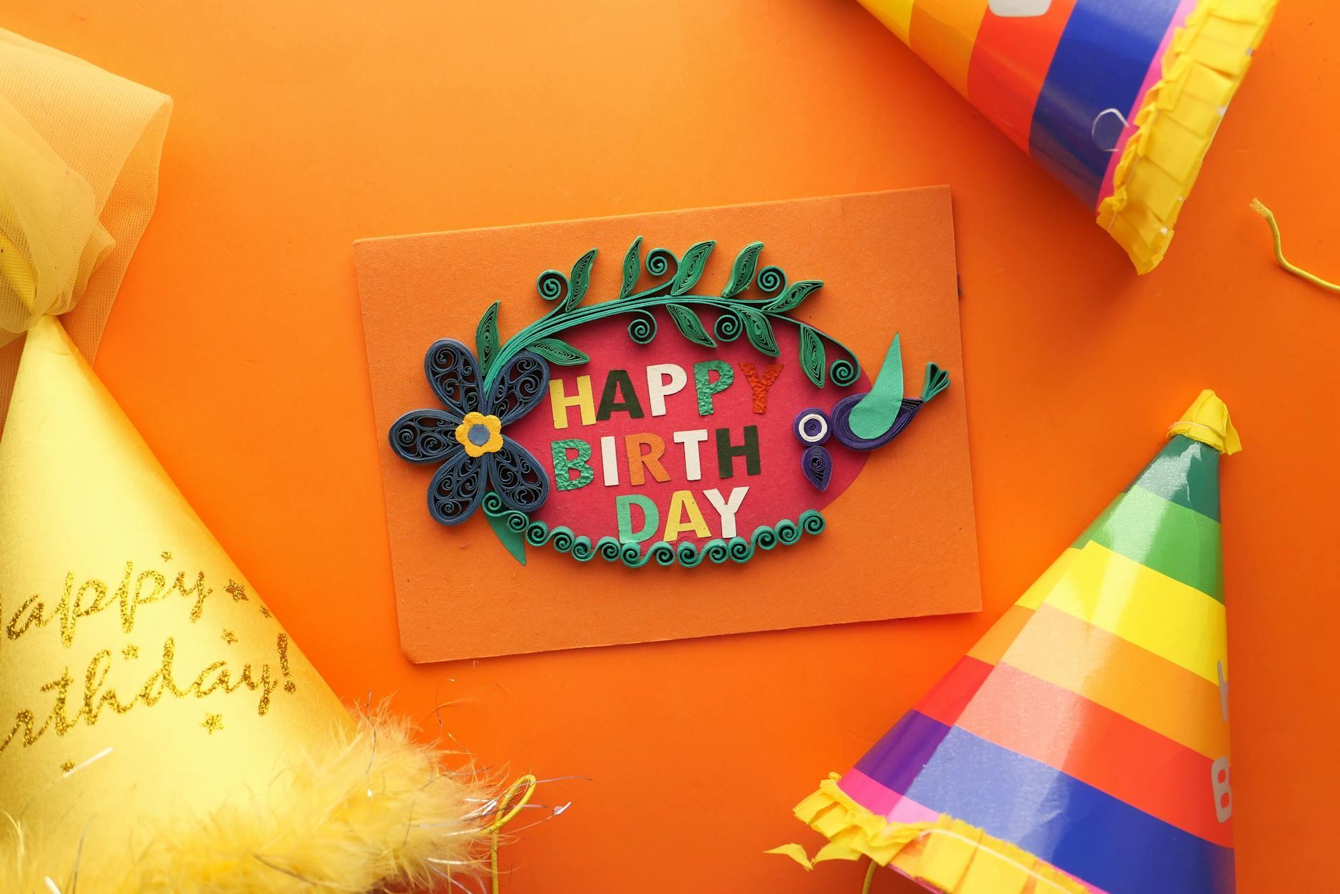happy birthday greeting card on orange surface